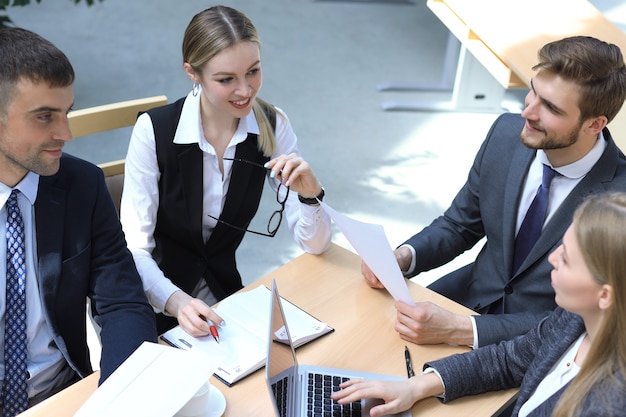 Image of business partners discussing documents and ideas at meeting.