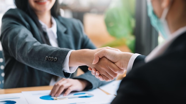 Image of businesswoman shaking hands to congratulate success