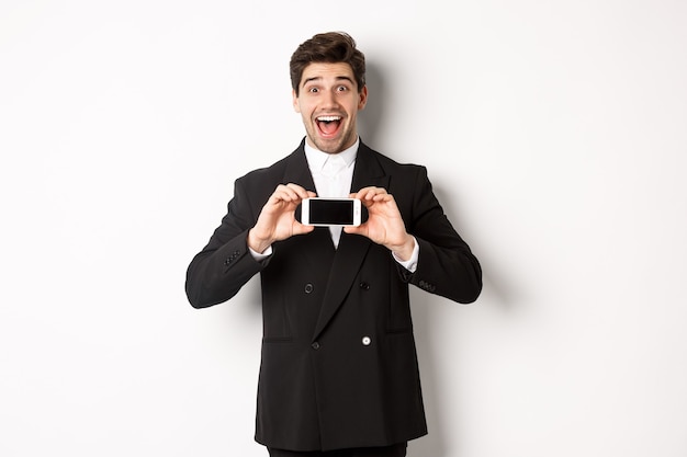 Image of cheerful, handsome man in black suit