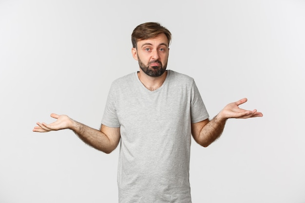 Image of clueless bearded man in casual t-shirt