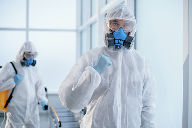 Image of a confident male sanitizer standing in an office lobby . concept of health protection.