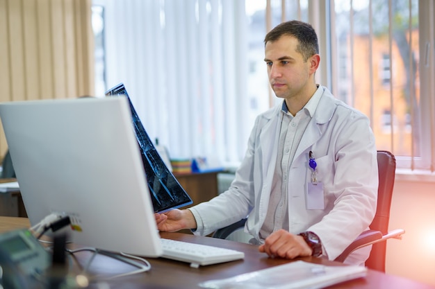 Image of a doctor looking at xray results.