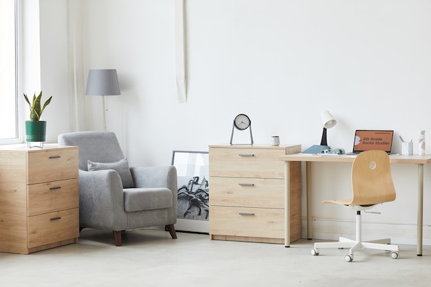 Image of domestic room with laptop on the table and modern furniture