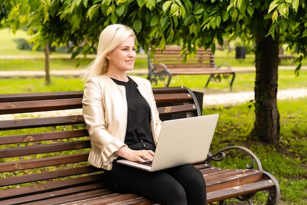 Image of elegant employer sitting on the bench.