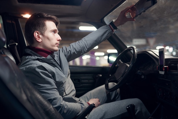 Image from side of man sitting in car