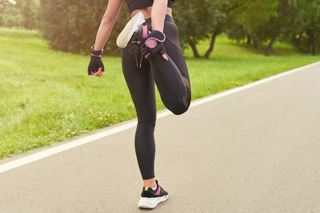 Image of a girl in the park doing a workout The concept of a healthy lifestyle