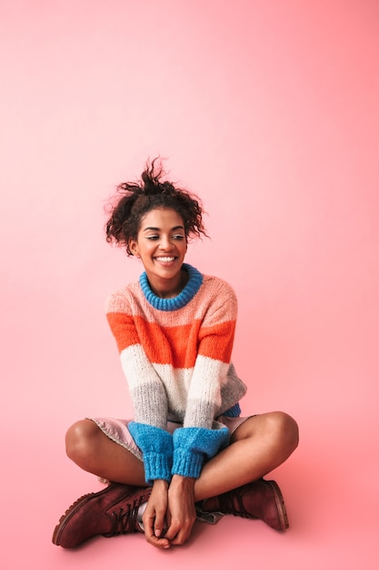 Photo image of a happy beautiful young african woman posing isolated.