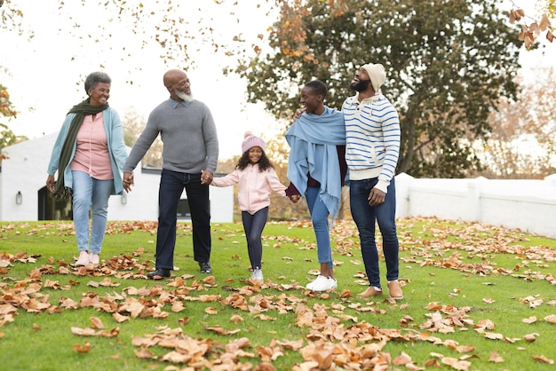 Image of happy multi generation african american family having fun outdoors in autumn. Extended family, spending quality time together concept.