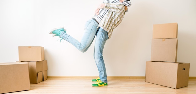 Image of hugging men and women among cardboard boxes