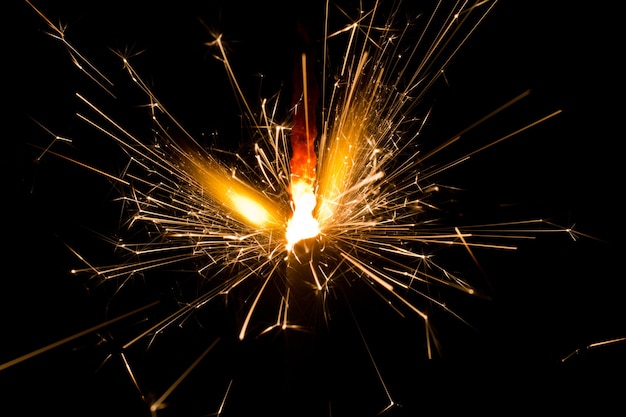 Image of Lit sparkler shooting off sparks in the night