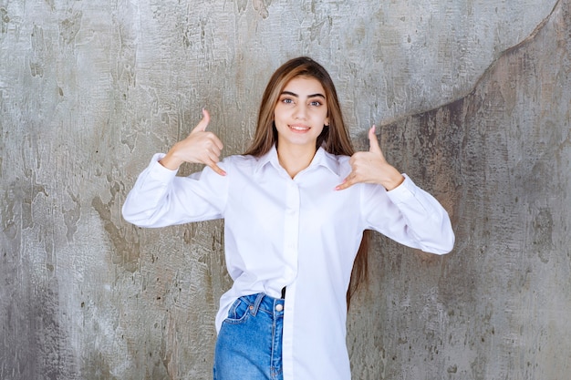 Image of long-haired young girl standing and signing to call