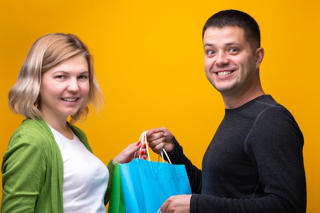 Image of man and blonde woman with shopping bags