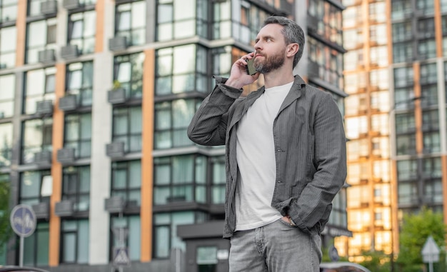 Image of man call on mobile phone man has mobile call outdoor man having mobile call