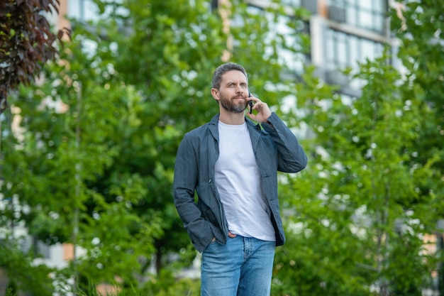 Image of man call on smartphone and talk man has smartphone call outdoor