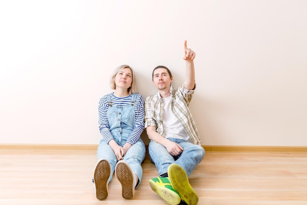 Image of man and woman sitting on floor