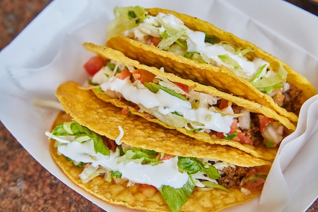 Image of Mexican hard shell taco with supreme toppings