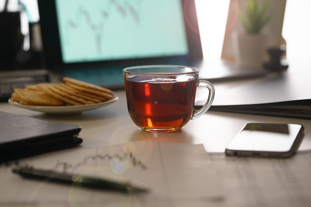 An image of a morning, office desk of a financial analyst close-up.