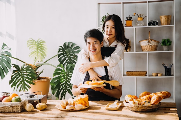 Image of newlywed couple cooking at home Asia young couple cooking together with Bread and fruit in cozy kitchen in home