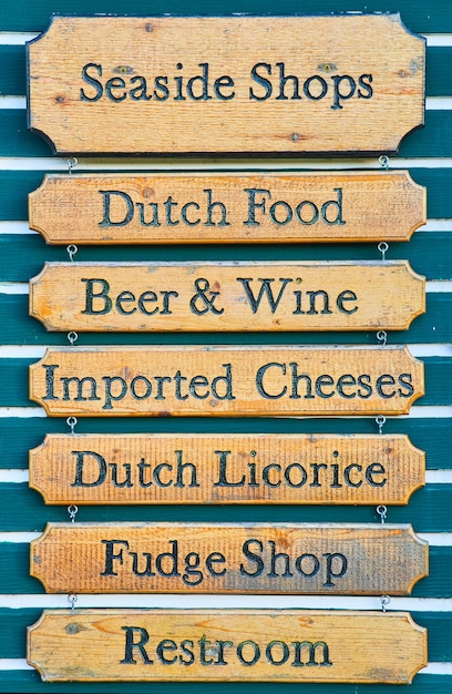 Photo image of old wall of signs in dutch shopping center on blue wall