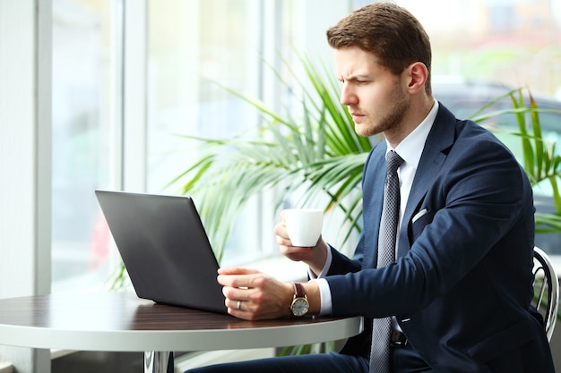 Image of a pensive businessman in a cafe