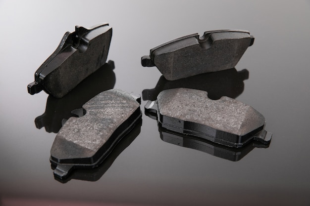 Image photograph of brake pads on a black and gray background