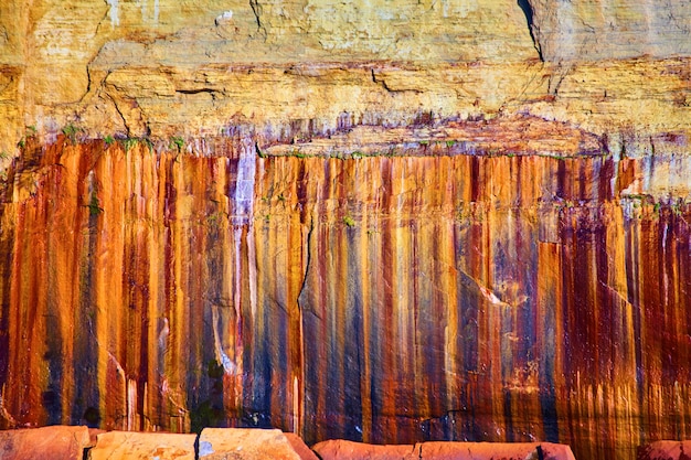 Image of Pictured Rocks with rust colors streaking down its side