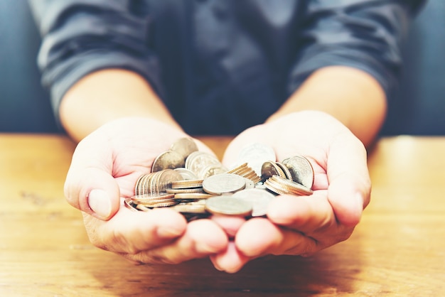 Image of plant growing on coins as a concept of growing business investment