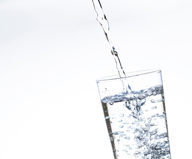 The image of pouring drinking water into a glass