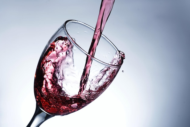 Image pouring red wine into a glass