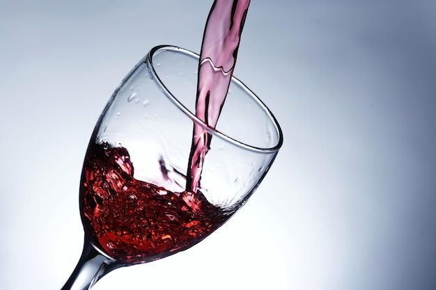 Image pouring red wine into a glass