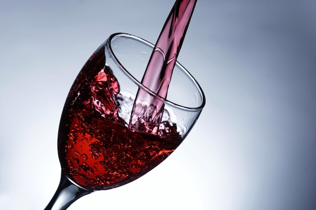 Image pouring red wine into a glass