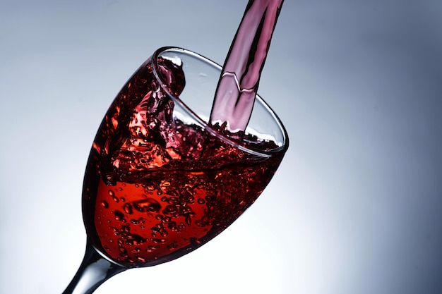 Image pouring red wine into a glass