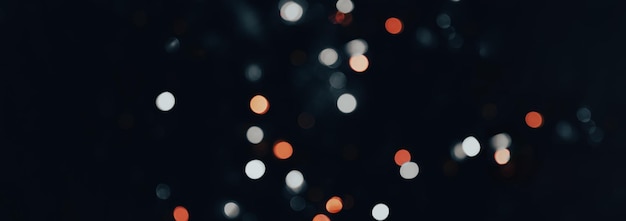 The image showcases a serene and mystical atmosphere created by scattered glowing white and orange bokeh lights against a dark background