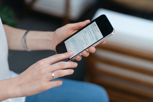 Image of a smartphone in the hands of a young woman