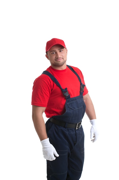 Image of smiling muscular man posing in worker suit