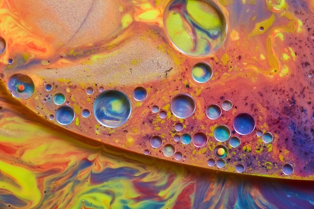 Image of Sparkling liquid surface of rainbow colors and cool colored spheres