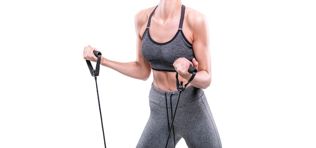 Image of a sports girl who trains with rubber bands in a white studio Fitness and bodybuilding concept