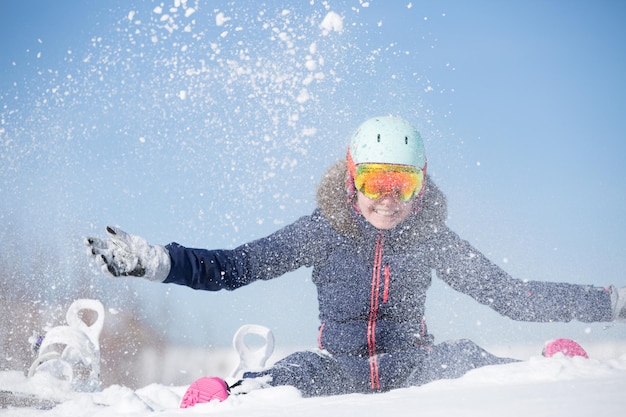 Image of sports woman sitting in snowdrift snowthrowing