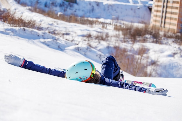 Image of sporty woman with snowboard lying