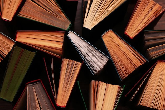 Image of a stack of hard back books on the end of the pages selective focus