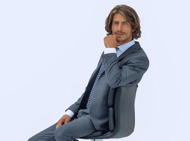 Image of successful businessman in elegant suit seated on chair