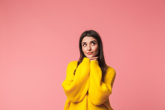 Image of a thinking young emotional woman posing isolated over pink.