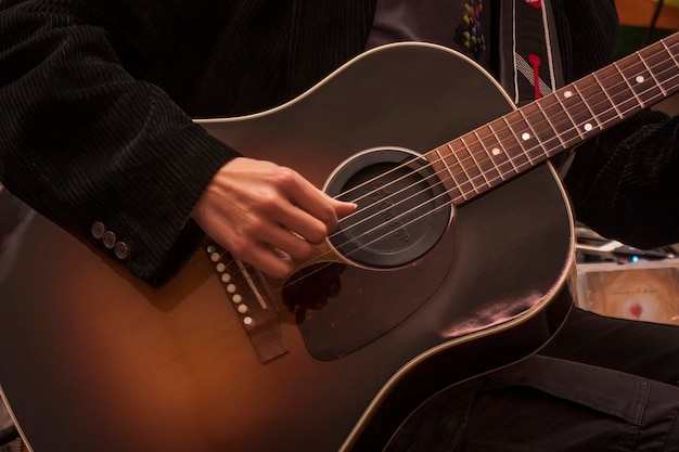 Image of a traditional guitar while being played by a musician
