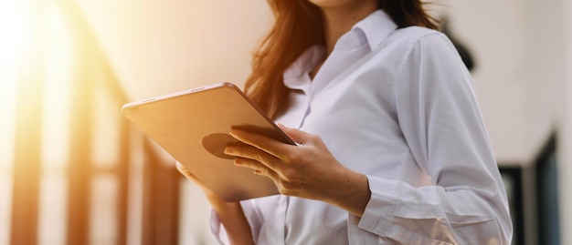 Image of two young businessmen using touchpad at meeting