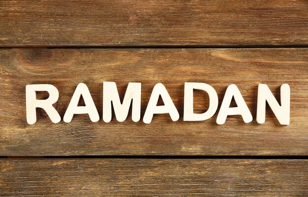 Photo image of word ramadan on wooden background close up