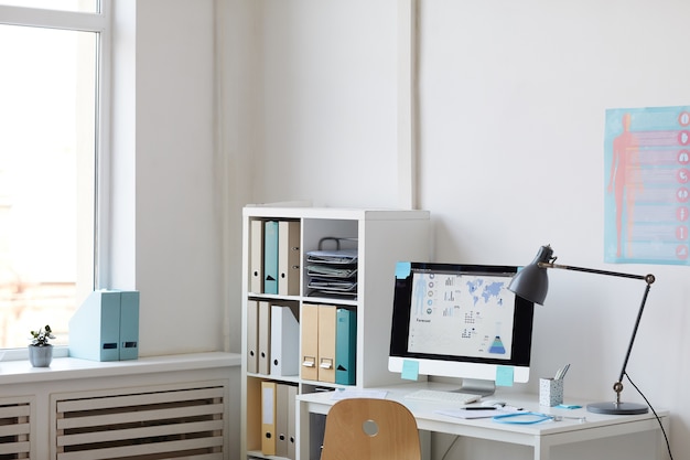 Image of workplace with computer on the table at modern doctor's office