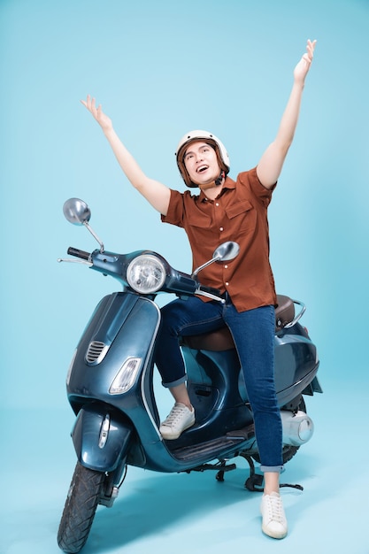 Image of yougn Asian man on motorbike