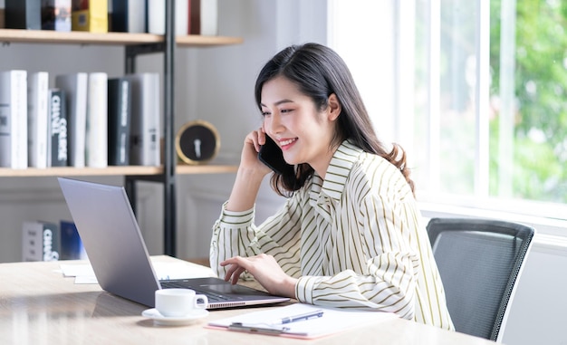 Image of young Asian business woman working at office