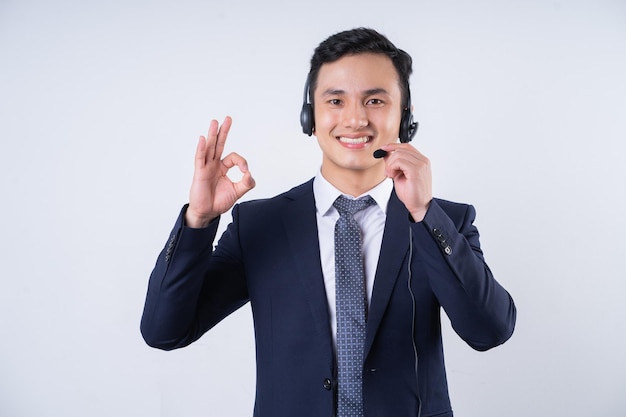 Image of young Asian businessman on background