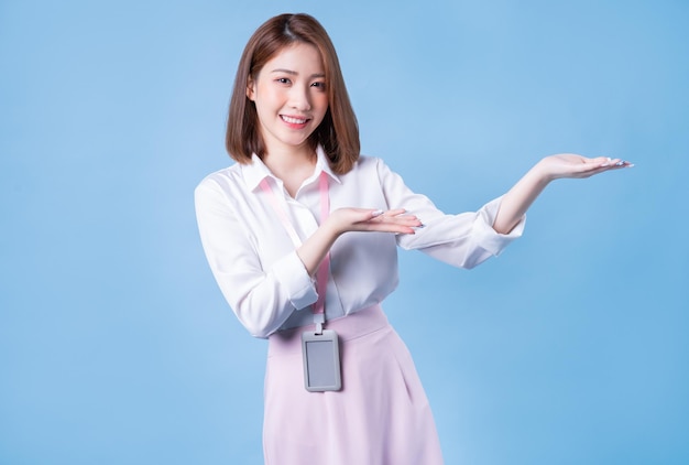 Image of young Asian businesswoman on blue background